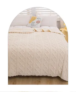 Soft cream textured knit blanket on bed with decorative face pillow and cozy lighting