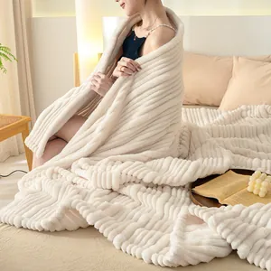 Cozy cream-colored ribbed flannel blanket wrapped around a model in a bedroom setting.