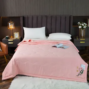 Soft pink mint summer quilt featuring mosquito repellent herbal embroidery in bedroom.