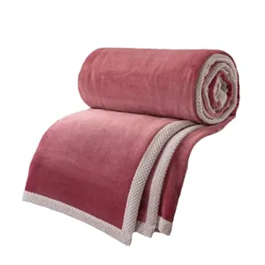 Soft pink milk fleece blanket with white textured waffle border for cozy home decor.