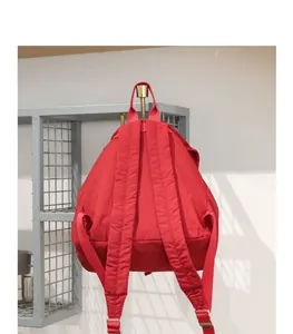 Vista trasera detallada de una mochila de lona roja con correas ajustables duraderas