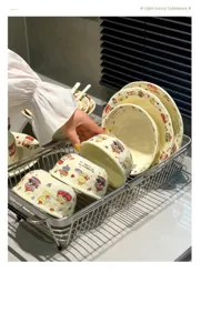 Detailed view of cream ceramic tableware set with cute bear print in a metal dish rack