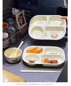 Detailed view of a cute cream-colored divided ceramic plate set with cartoon prints