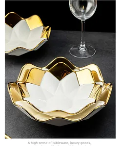 Close-up of luxury white ceramic star plates with elegant gold rim finish.