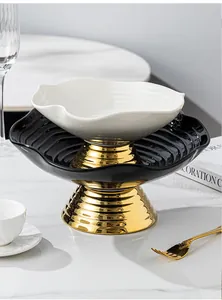 Elegant two-tier ceramic fruit bowl with wavy edges and gold pedestal bases