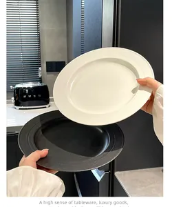 Detailed view of minimalist black and white ceramic plates with textured surface