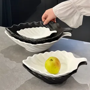 Elegant leaf-shaped ceramic salad bowls in monochrome black and white for modern home dining decor
