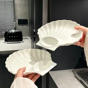 Elegant white shell-shaped ceramic plate with built-in dipping saucer for snacks and sushi