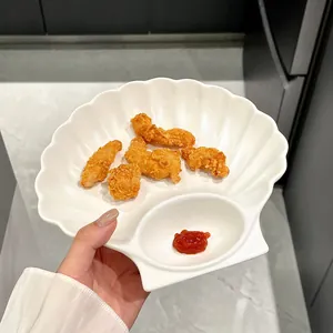 Shell-shaped white ceramic plate with dipping compartment
