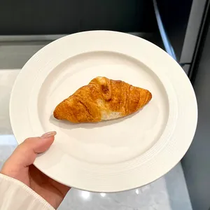Minimalist white ceramic flat plate for steak and snacks with textured rim