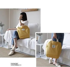Lifestyle view of large capacity yellow canvas tote bag with a minimalist design.