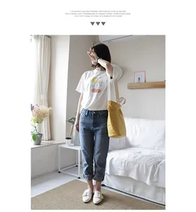 Casual yellow canvas shoulder bag shown on a model in a minimalist room setting
