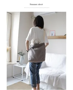 Minimalist grey canvas shoulder bag for women shown in an indoor lifestyle setting