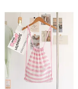 Vista detallada de mochila de punto a rayas rosas y blancas con textura de algodón