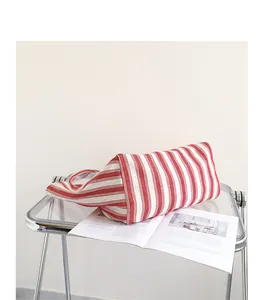 Vista dettagliata di una borsa tote casual in tela a righe rosse e bianche su un tavolo