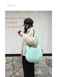 Detailed view of a stylish mint green quilted nylon shoulder bag with grid pattern texture