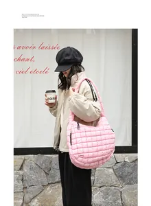 Fashionable pink quilted puffer shoulder bag shown in detail on an Asian model.