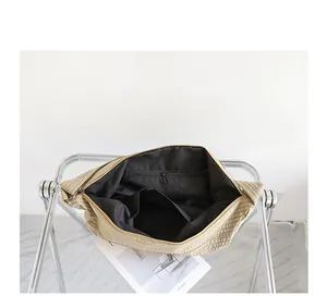 Detalle del forro negro y el bolsillo con cremallera del bolso de lona a cuadros