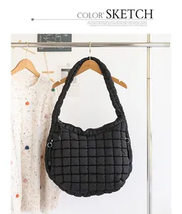 Black quilted nylon hobo bag hanging on a stylish wooden rack with a cream sweater