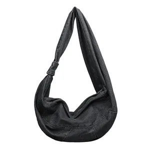 Japanese style black denim hobo bag with knotted shoulder strap and zipper closure
