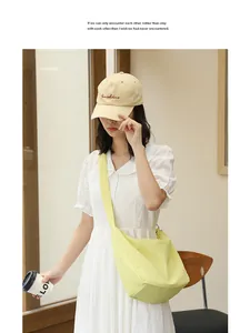 Casual chic model wearing a pleated lime green nylon crossbody bag in a cozy cafe setting