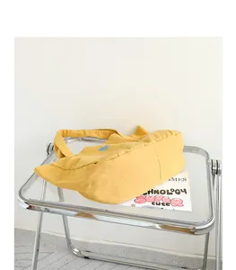 Detailed view of the vintage washed yellow canvas tote bag on a modern table.