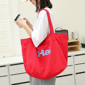 Stylish large red washed canvas tote bag featuring a blue 'Hai' letter print design