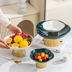 Elegant plum-shaped ceramic fruit platter with gold pedestal for modern living room decor