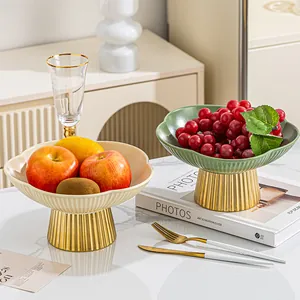Modern plum blossom ceramic fruit bowls featuring elegant gold fluted pedestal bases
