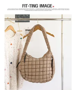 Macro view of a stylish quilted khaki nylon shoulder bag with soft padded texture