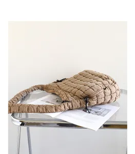 Modern khaki quilted nylon shoulder bag with a checkered pattern and ruffled strap