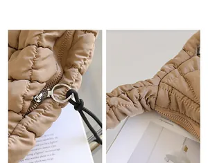 Detailed view of the silver ring zipper and pleated quilted texture on beige bag