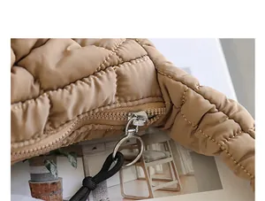 Close-up of a khaki quilted nylon handbag showing zipper detail and stitching texture