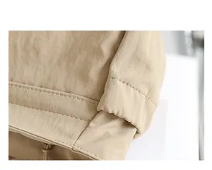 Makroansicht der hochwertigen Nylon-Stofftextur und Nähte der khakifarbenen Umhängetasche