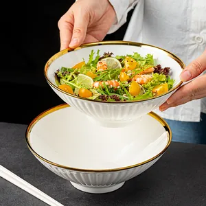 Japanese style white ceramic ramen bowl with elegant gold rim and vertical ribbed design