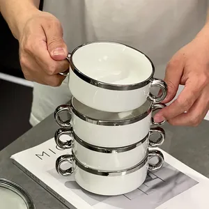 Elegant white ceramic bowls with silver rims and double handles for dessert and breakfast.
