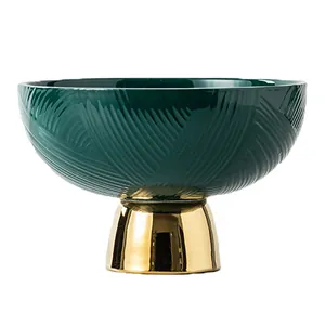 Elegant dark green ceramic fruit bowl with textured patterns and a luxury gold pedestal base