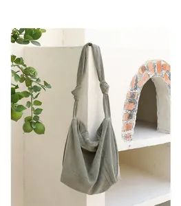 Detail view of olive green corduroy hobo bag with a stylish knotted shoulder strap