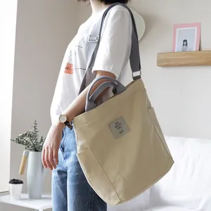 Casual beige canvas tote bag with large capacity and adjustable strap for women