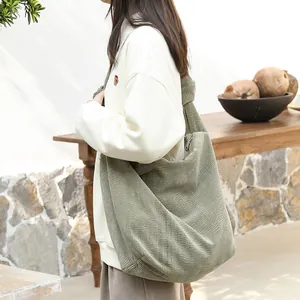 Casual green corduroy crossbody bag with a knotted shoulder strap