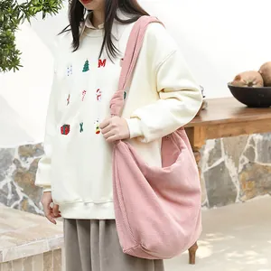 Pink corduroy crossbody bag with stylish knot strap and casual minimalist design.