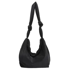 Minimalist black corduroy shoulder bag with knotted straps and casual hobo design