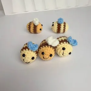 Detailed view of hand-crocheted bee keychains with cute striped patterns.