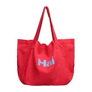 Minimalist red canvas tote bag with light blue Hai letter print and vintage washed texture