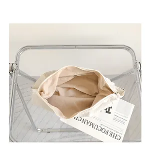 Top view of cream pleated shoulder bag interior showing compartment and zipper pocket