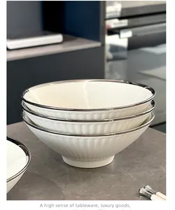 Close-up of stacked 8-inch ceramic ramen bowls with elegant silver rims