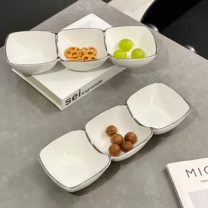 Elegant three-compartment white ceramic snack bowl with silver rim for snacks and fruits