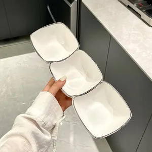 Creative three-compartment white ceramic snack bowl with silver rim for elegant snacks