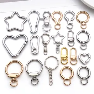 Detailed view of various metal keychain accessories in star and heart shapes and finishes