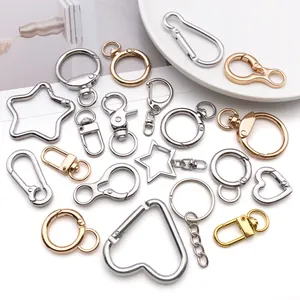 Assorted metal keychain hardware featuring heart, star, and circular rings in multiple finishes